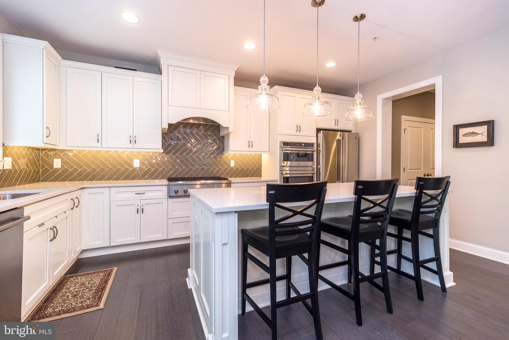 1 White Field Lower Gwynedd, PA 19002 - Photo 14 of 53 a kitchen with stainless steel appliances granite countertop a table chairs stove refrigerator and cabinets
