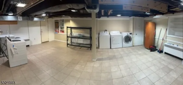 a view of water heater room with wooden floor