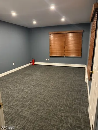 an empty room with wooden floor and entrance
