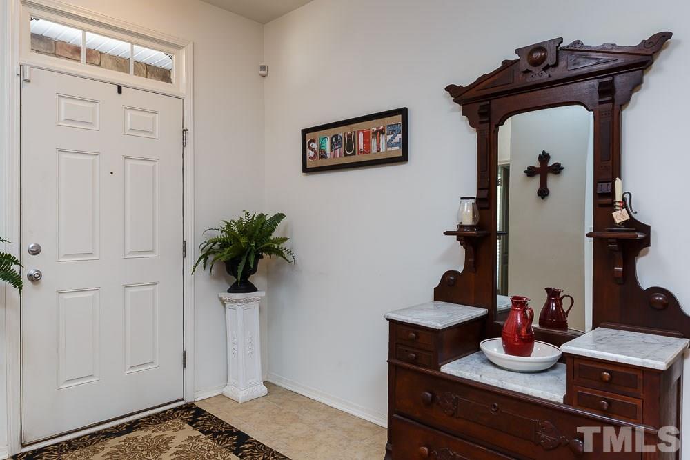 131 Daneborg Road Durham, NC 27703 - Photo 2 of 25 Welcome guests from the stone, covered, stoop onto tile floors beneath a transom window. Large enough to comfortably accommodate designer decorating.