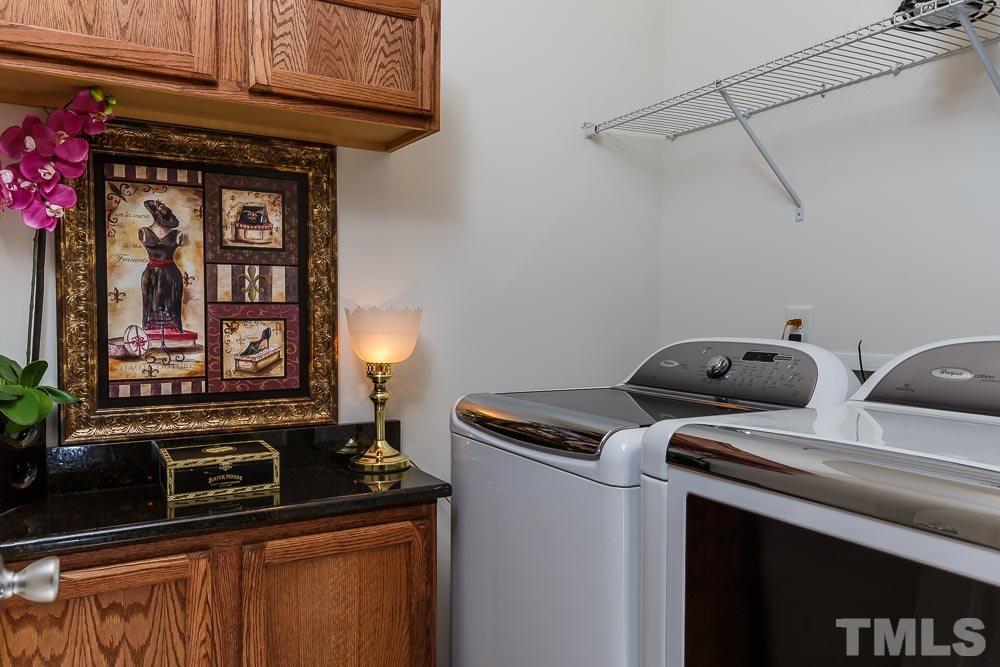 131 Daneborg Road Durham, NC 27703 - Photo 5 of 25 Even the laundry room has special touches with shelving, cabinets, and a granite folding counter.