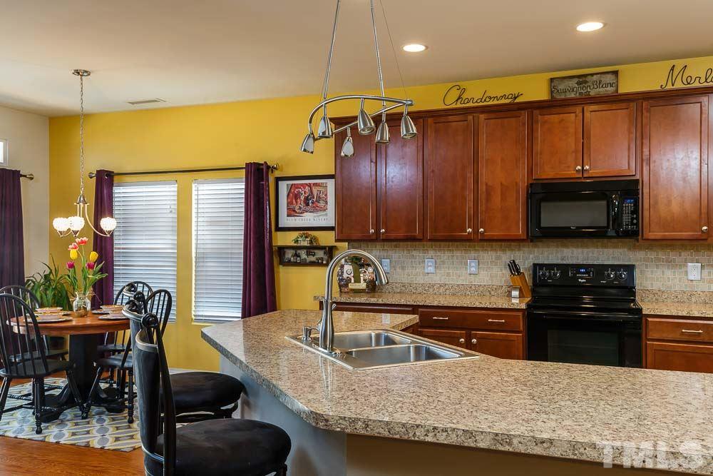 131 Daneborg Road Durham, NC 27703 - Photo 7 of 25 Friendly and open, the centerpiece of this kitchen is the huge island with sink and expansive counters for multiple chefs, serving buffet-style, or helping with homework during meal prep!