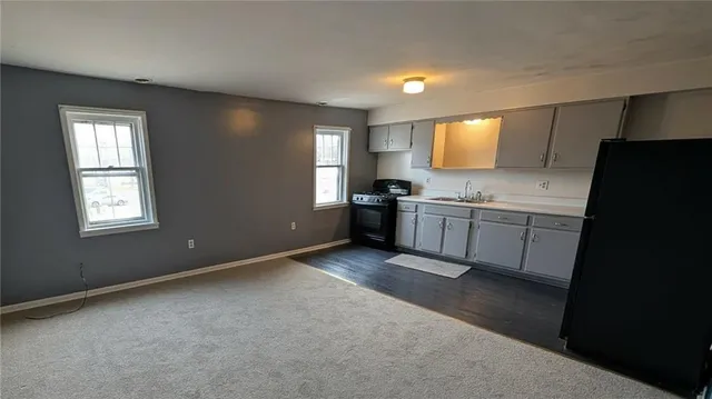 a view of a kitchen with a sink cabinets and a window