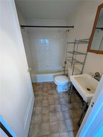a view of a hallway with wooden floor and stairs