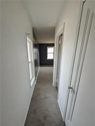 an empty room with closet and a chandelier fan