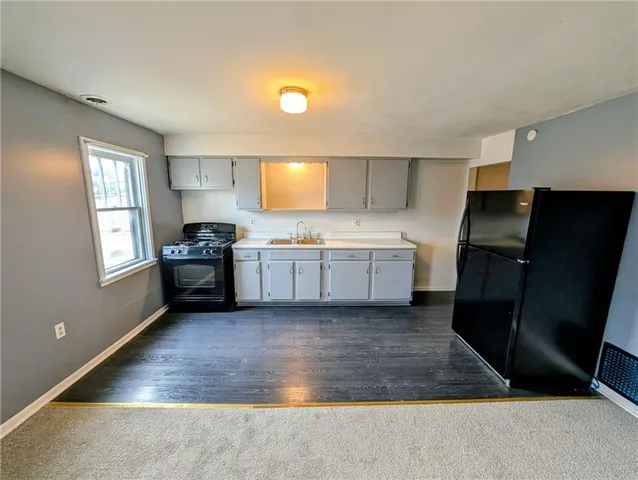 a kitchen with a sink appliances and cabinets