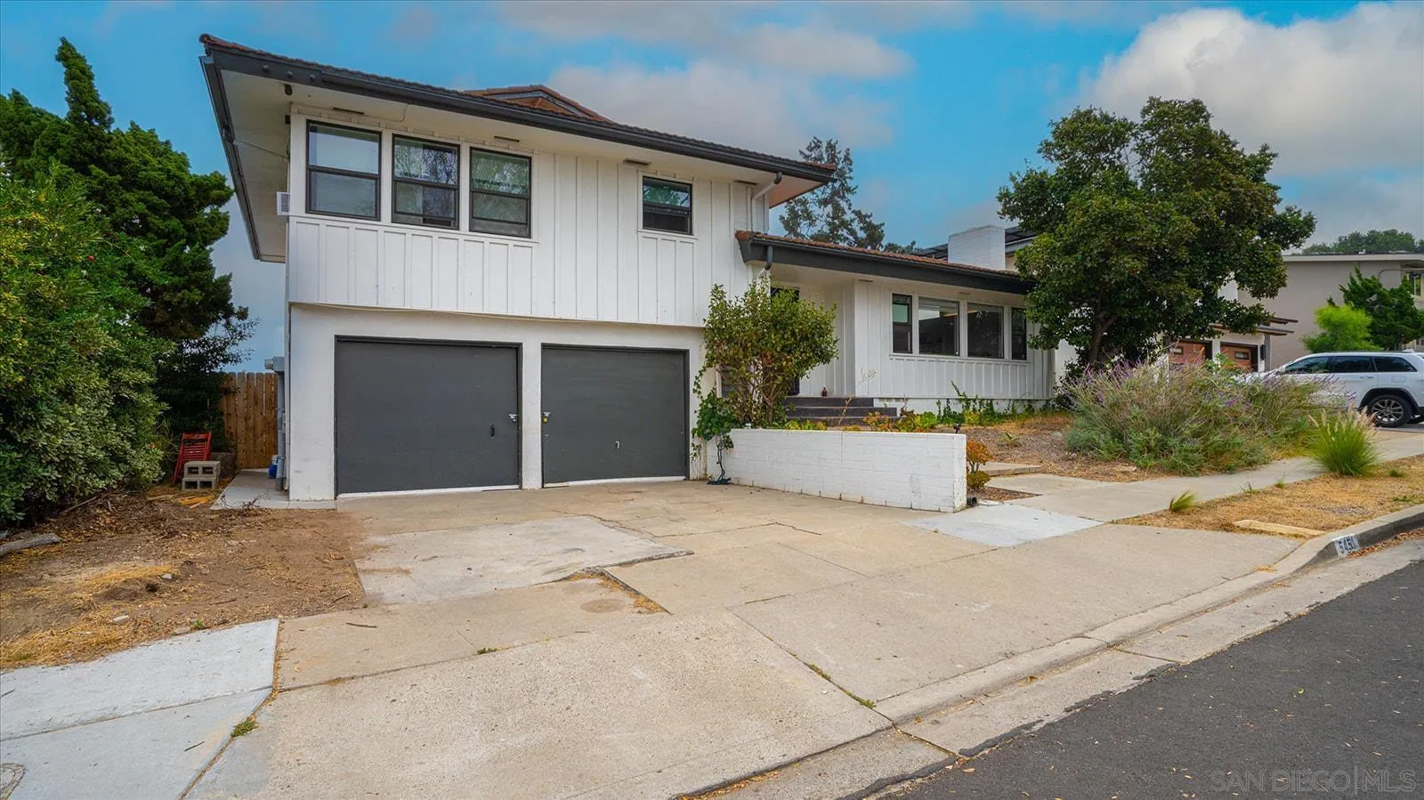 a front view of a house with a yard and a garage