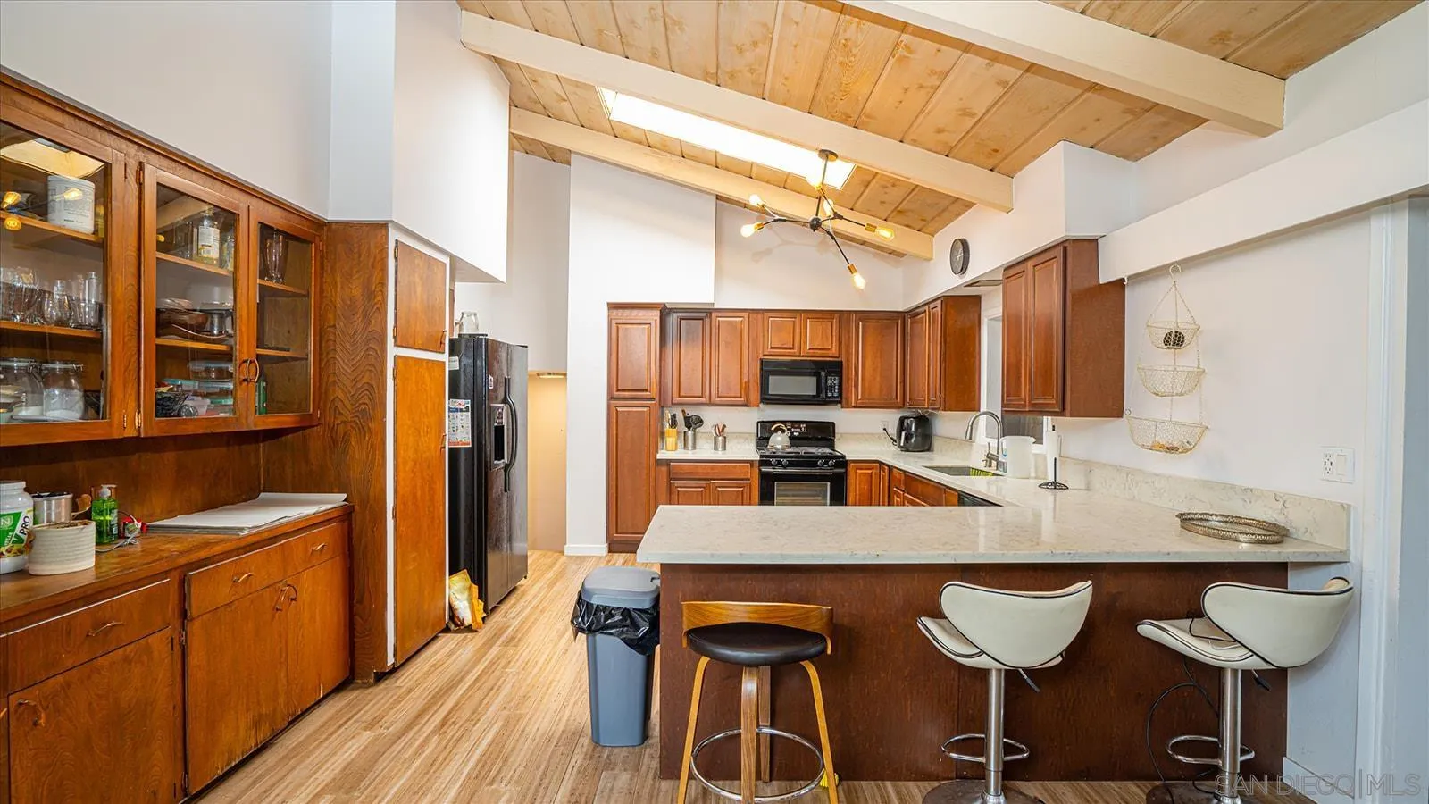 5451 Redding Road San Diego, CA 92115 - Photo 11 of 37 a kitchen with granite countertop a sink cabinets and refrigerator