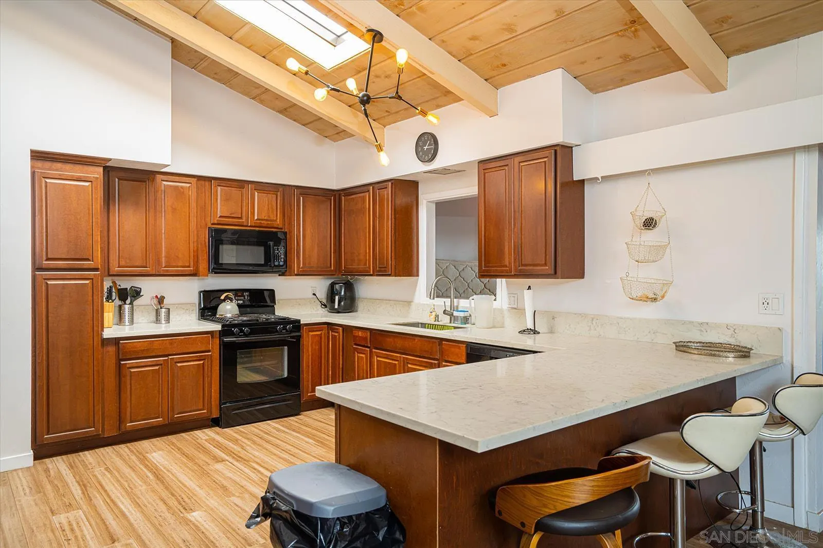 5451 Redding Road San Diego, CA 92115 - Photo 12 of 37 a kitchen with stainless steel appliances a sink a stove a refrigerator cabinets and dining table