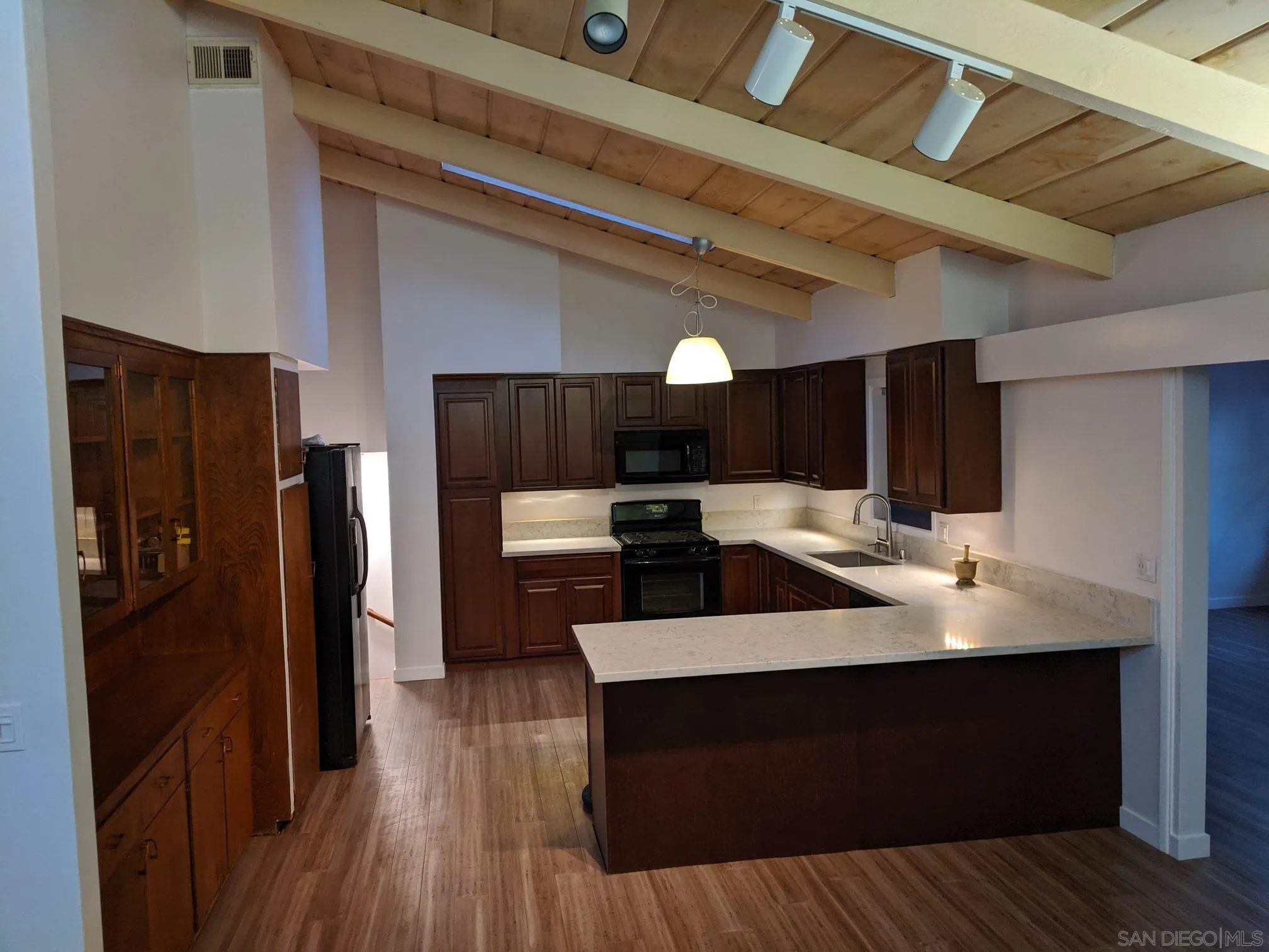 5451 Redding Road San Diego, CA 92115 - Photo 13 of 37 a kitchen with a sink stainless steel appliances and cabinets