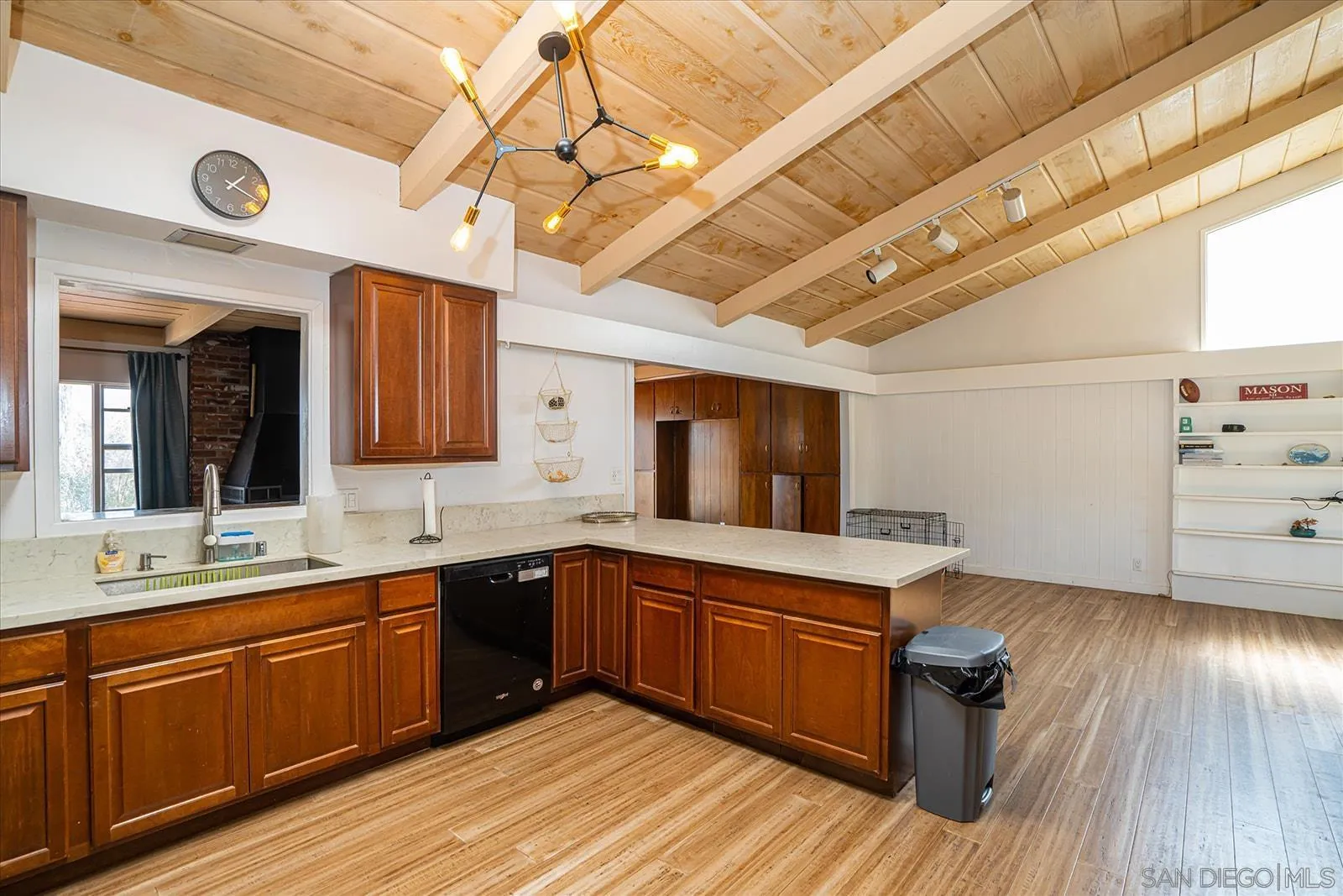 5451 Redding Road San Diego, CA 92115 - Photo 14 of 37 a kitchen with sink cabinets and wooden floor