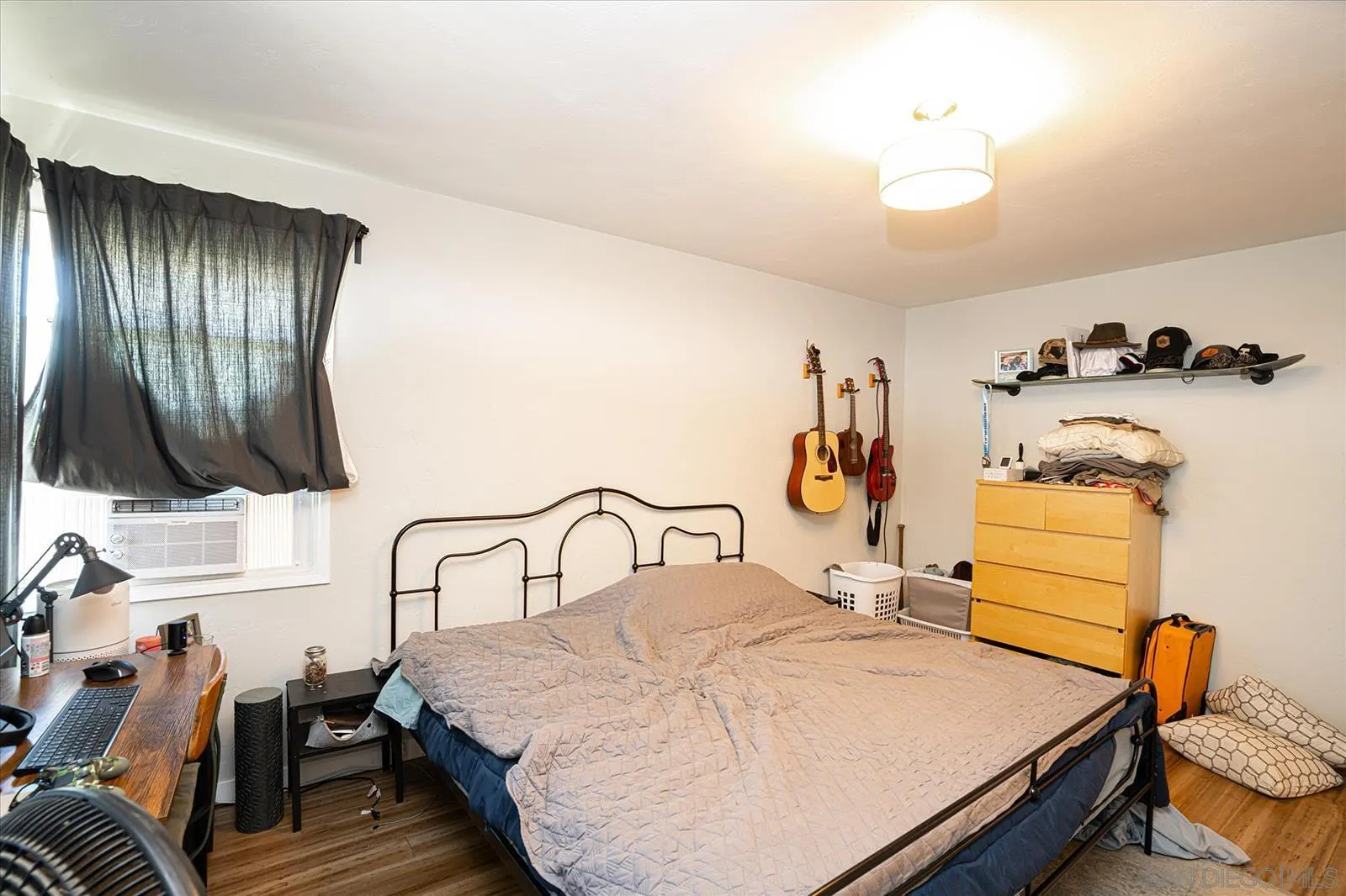 5451 Redding Road San Diego, CA 92115 - Photo 18 of 37 a bedroom with a bed and wooden floor