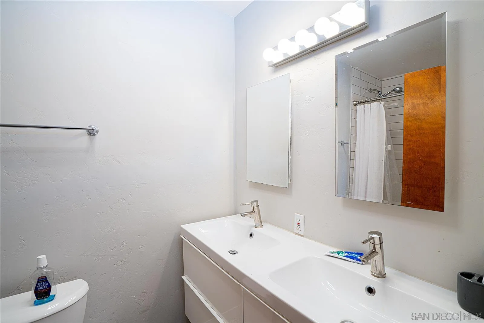 5451 Redding Road San Diego, CA 92115 - Photo 19 of 37 a bathroom with a sink and a mirror