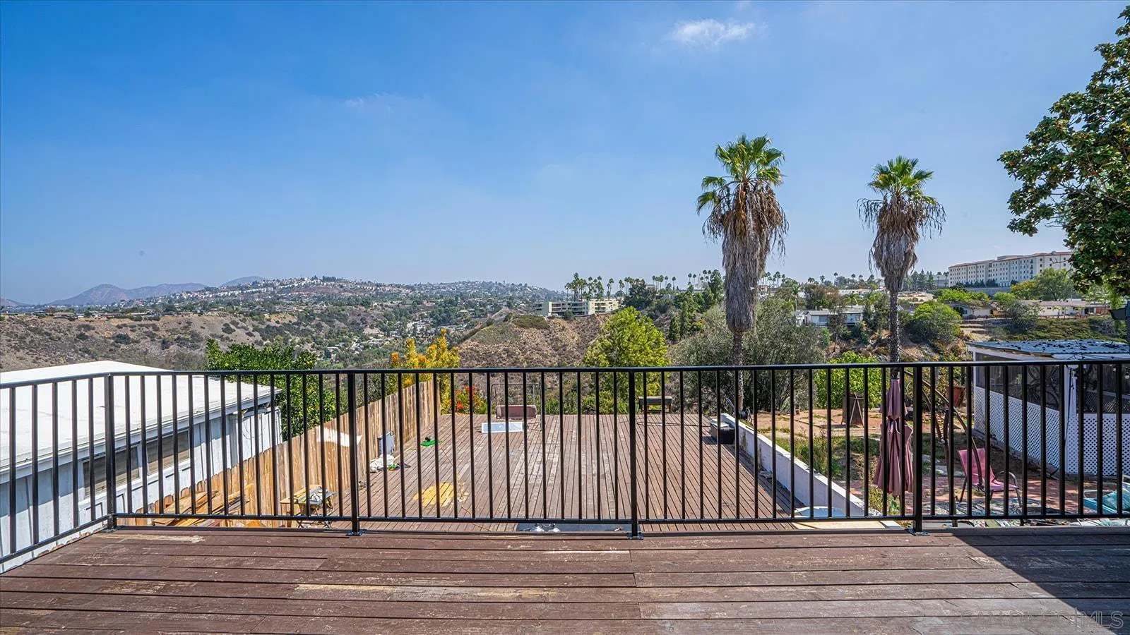 5451 Redding Road San Diego, CA 92115 - Photo 26 of 37 a view of balcony with wooden floor and fence