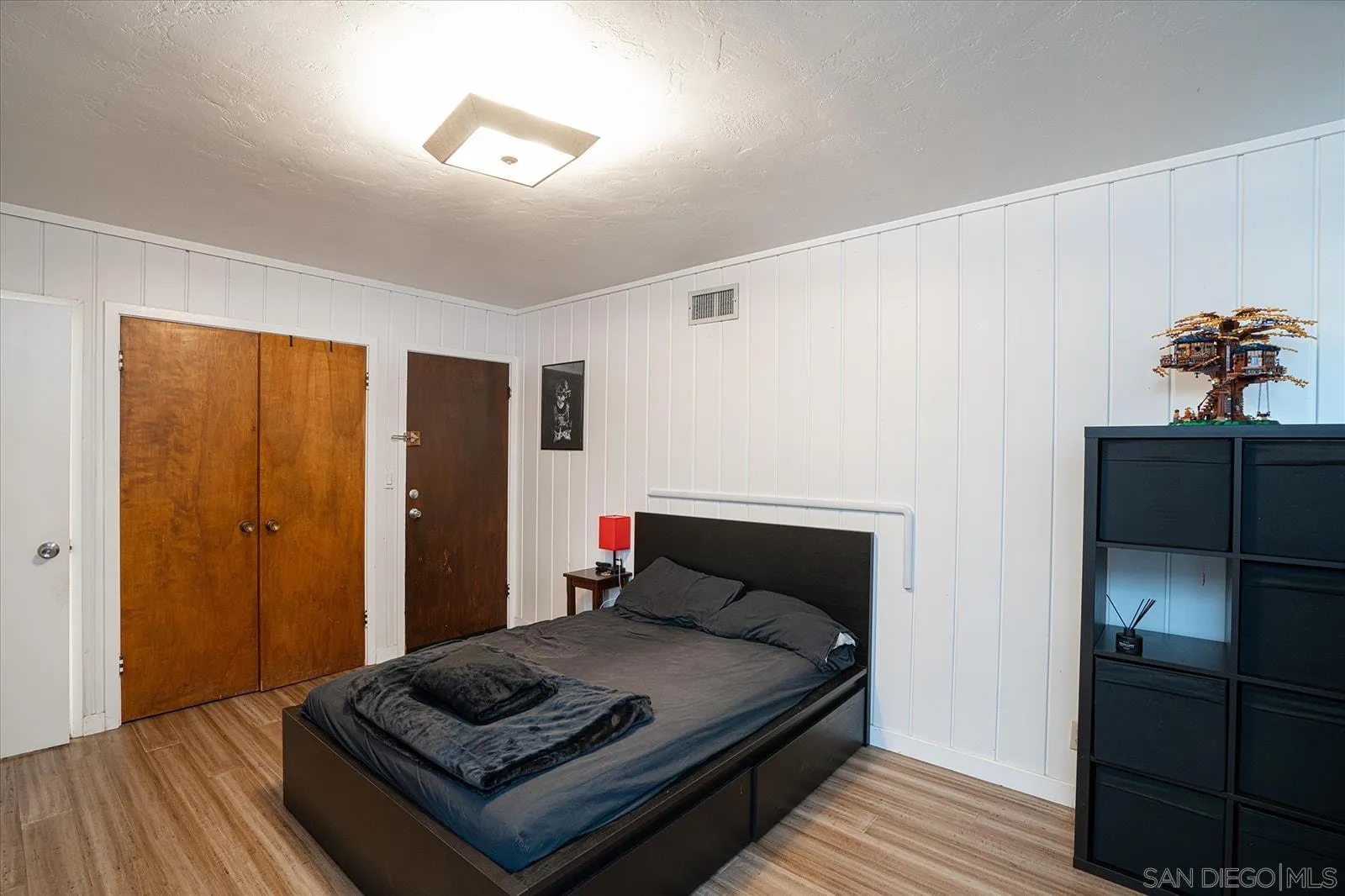 5451 Redding Road San Diego, CA 92115 - Photo 27 of 37 a bedroom with a bed and wooden floor