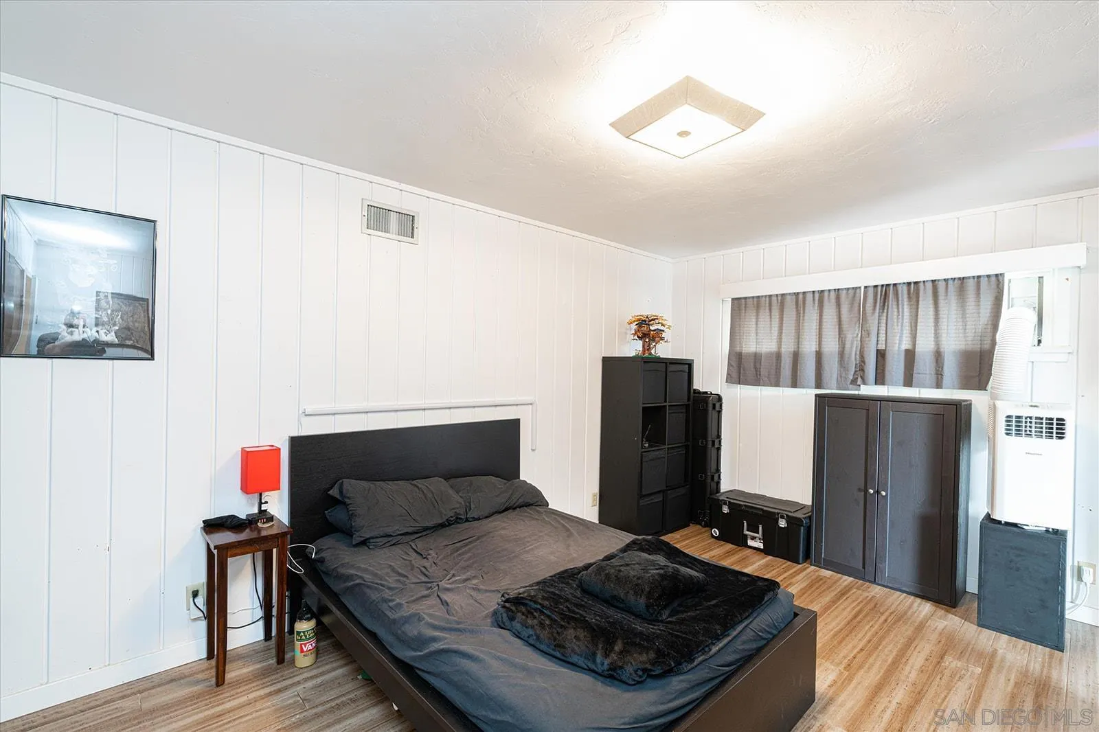 5451 Redding Road San Diego, CA 92115 - Photo 28 of 37 a bedroom with a bed and a refrigerator