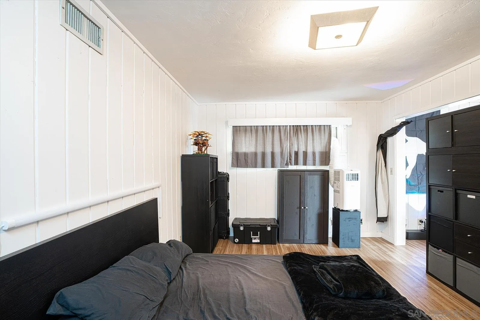 5451 Redding Road San Diego, CA 92115 - Photo 29 of 37 a bedroom with a bed and a refrigerator