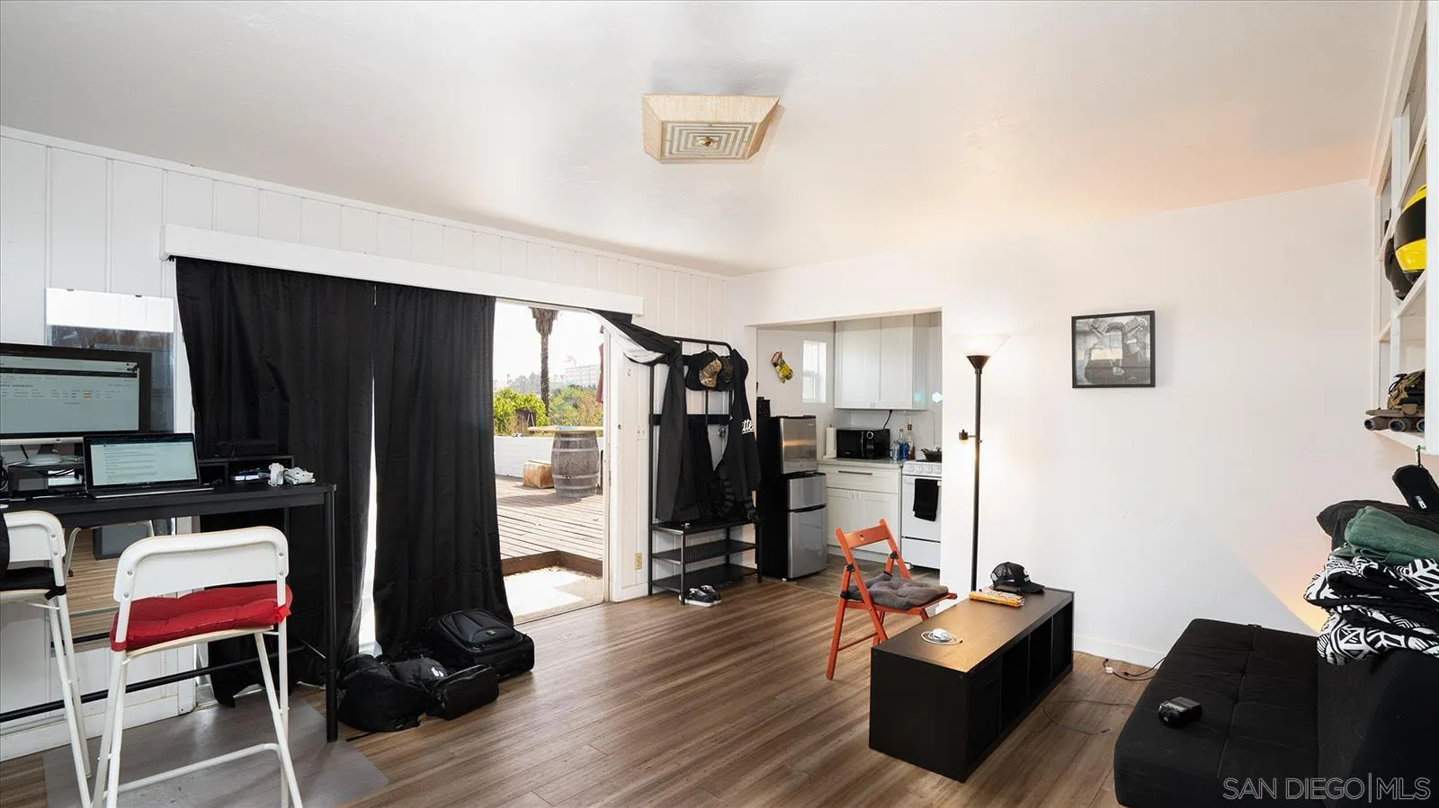 5451 Redding Road San Diego, CA 92115 - Photo 32 of 37 a living room with furniture flat screen tv and closet