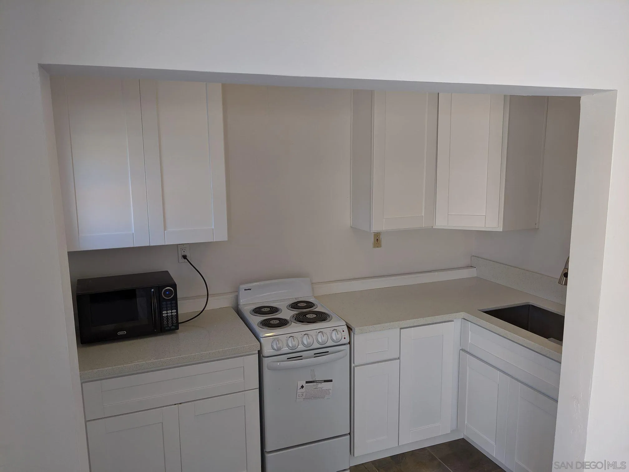 5451 Redding Road San Diego, CA 92115 - Photo 35 of 37 a kitchen with white cabinets and white appliances