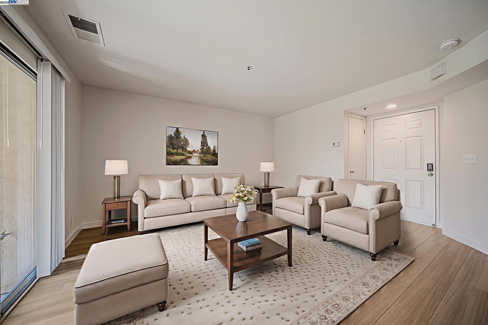 4772 Nicol Common, Unit 101 Livermore, CA 94550 - Photo 1 of 1 a living room with furniture and wooden floor