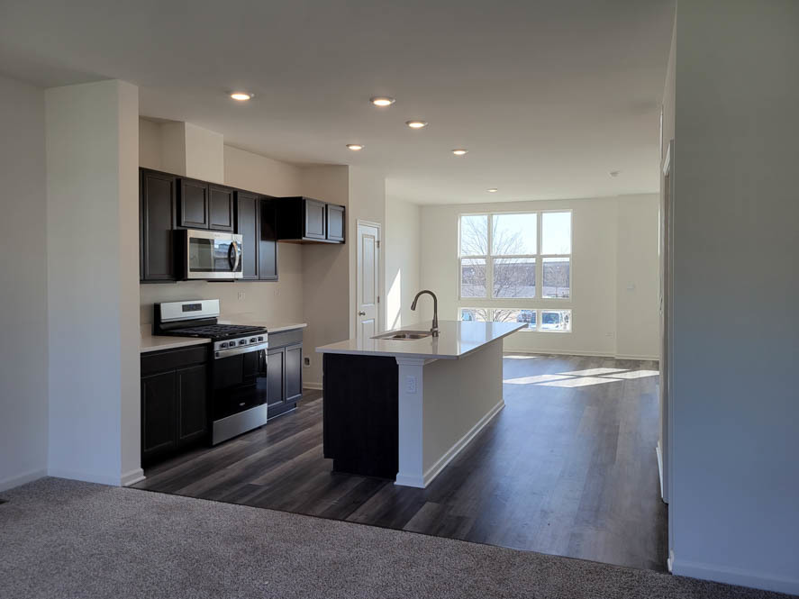358 Summit Circle Lombard, IL 60148 - Photo 22 of 55 a kitchen with stainless steel appliances kitchen island granite countertop a stove a sink and a refrigerator