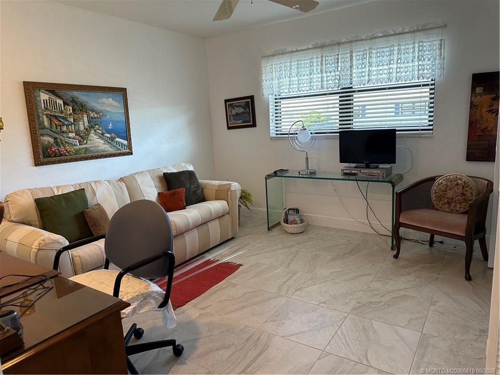 755 Saturn Street, Unit F205 Jupiter, FL 33477 - Photo 17 of 19 a living room with furniture and a window