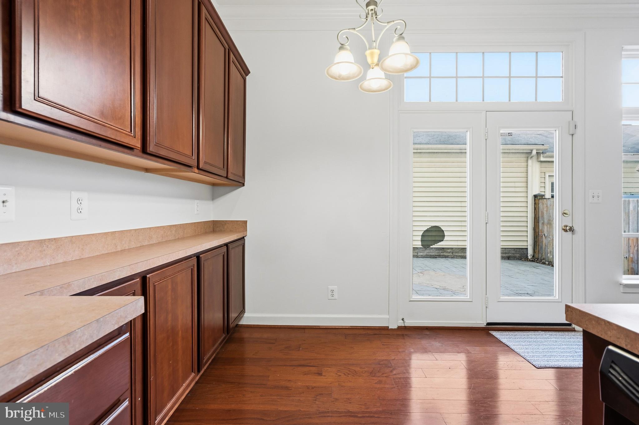 9227 Ribbon Falls Loop Bristow, VA 20136 - Photo 27 of 53 a view of a kitchen with wooden floor and cabinets