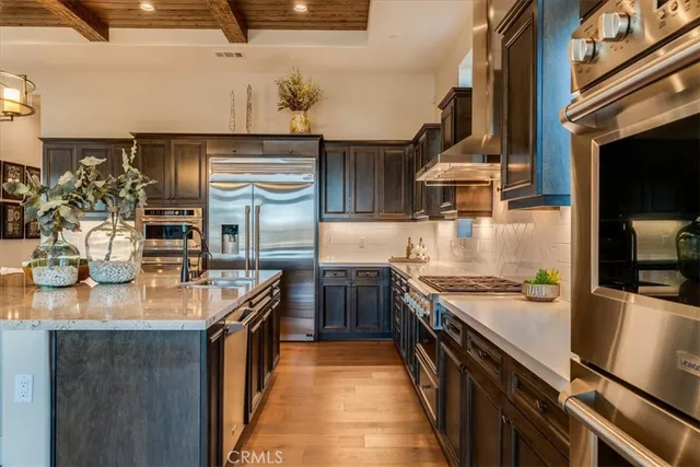 a kitchen with stainless steel appliances granite countertop a sink and stove
