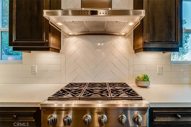 a stove top oven sitting inside of a kitchen
