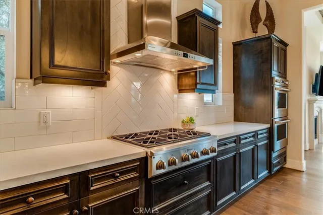 a kitchen with stainless steel appliances granite countertop a stove and a refrigerator