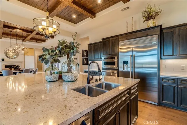 a kitchen with sink and refrigerator