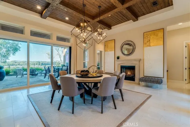 a view of a dining room with furniture a rug and wooden floor