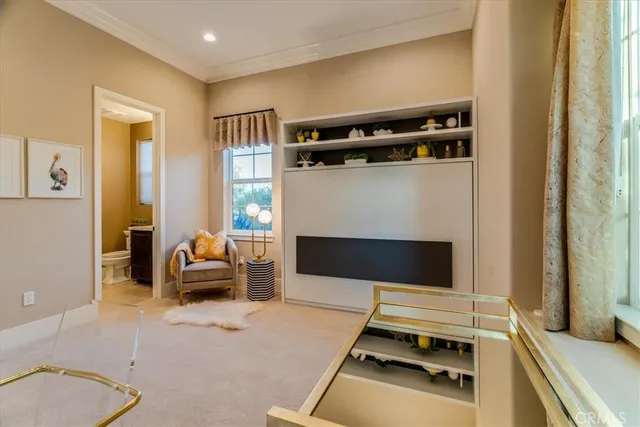 a view of a patio with couches table and chairs with potted plants and large tree