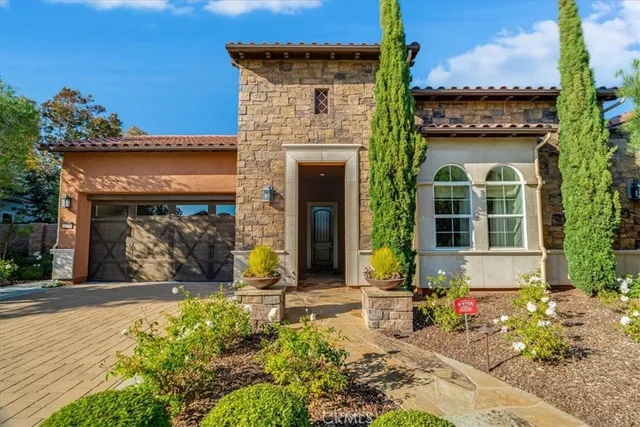 front view of a brick house with a small yard