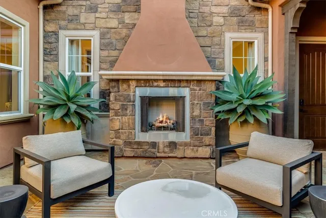 a view of two chairs and table in patio
