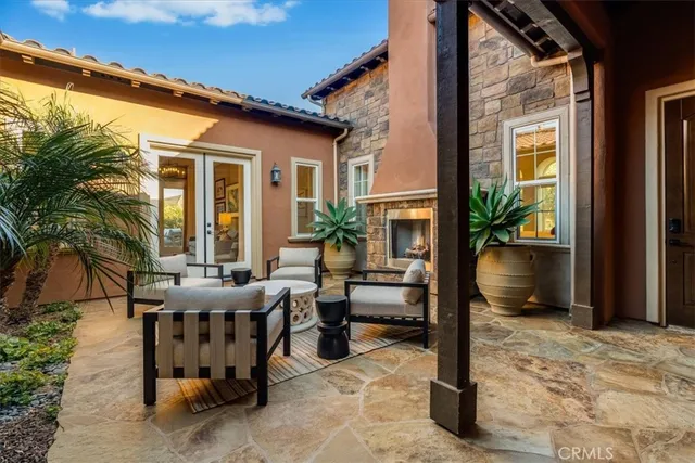 a view of a patio with table and chairs with wooden floor and fence