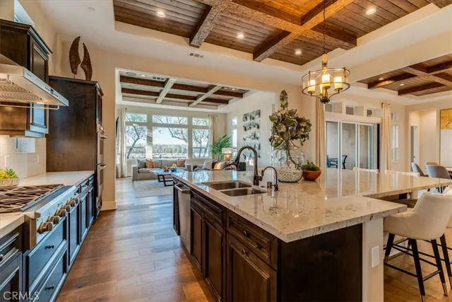 a kitchen with granite countertop a sink appliances and cabinets
