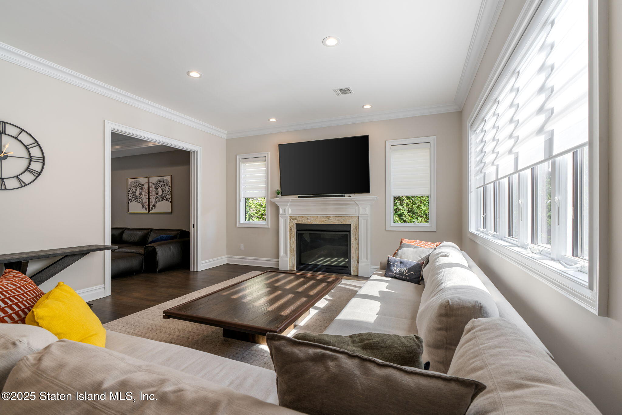 312 London Road Staten Island, NY 10306 - Photo 12 of 82 a living room with furniture a fireplace and a flat screen tv