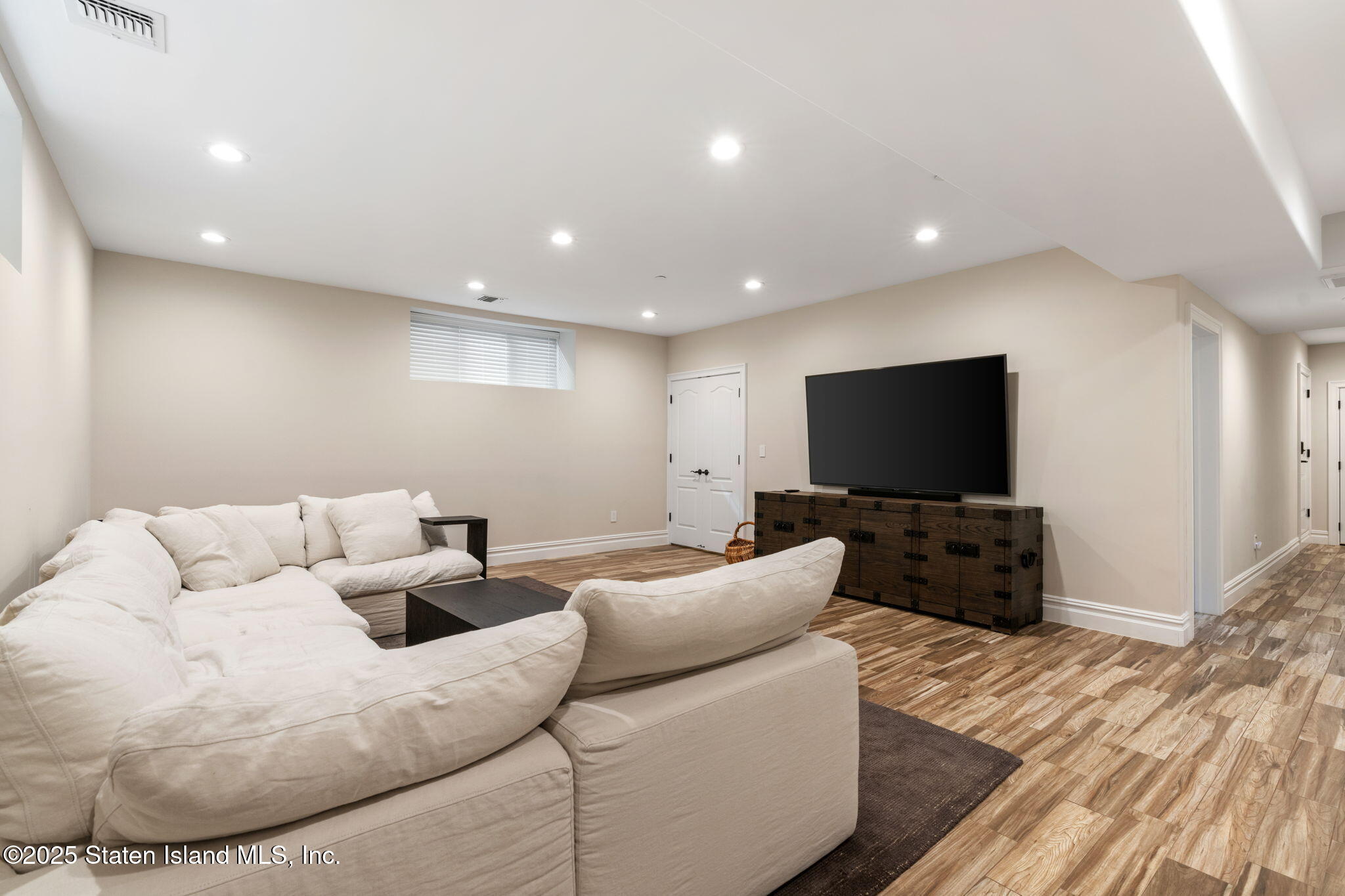 312 London Road Staten Island, NY 10306 - Photo 61 of 82 a living room with furniture and a flat screen tv