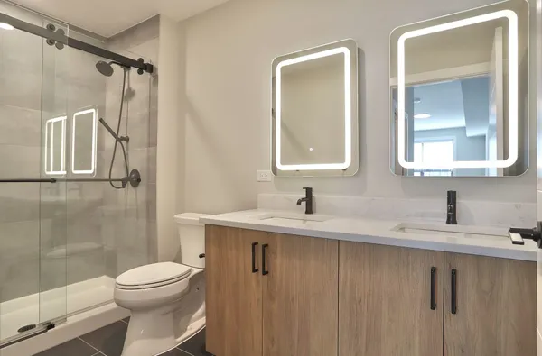 a bathroom with a granite countertop sink toilet and shower