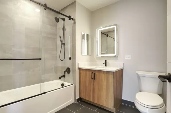 a bathroom with a sink a toilet and shower