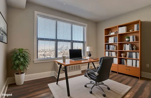 a view of a workspace with a window and potted plant