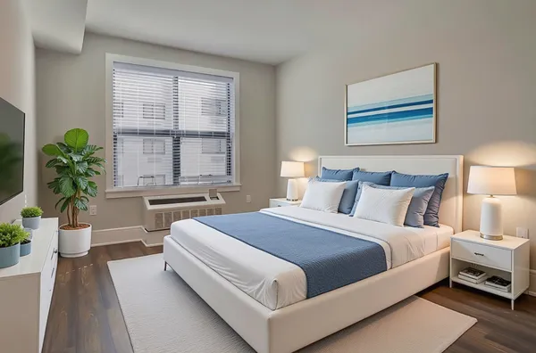 a bedroom with bed and a large window