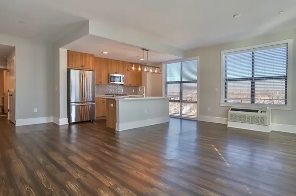 a view of a kitchen with a sink cabinets and wooden floor