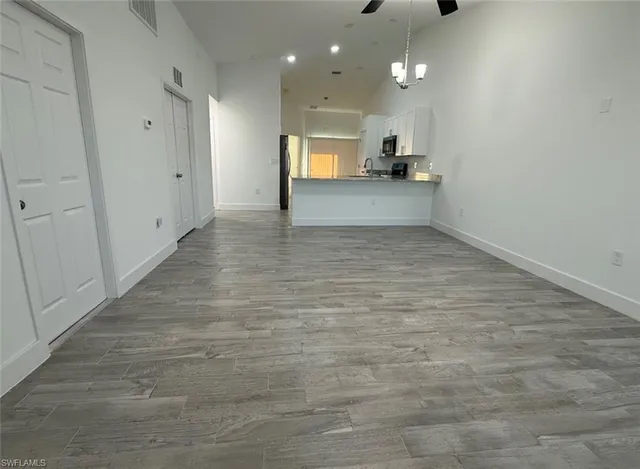 a view of a kitchen with a sink and cabinets