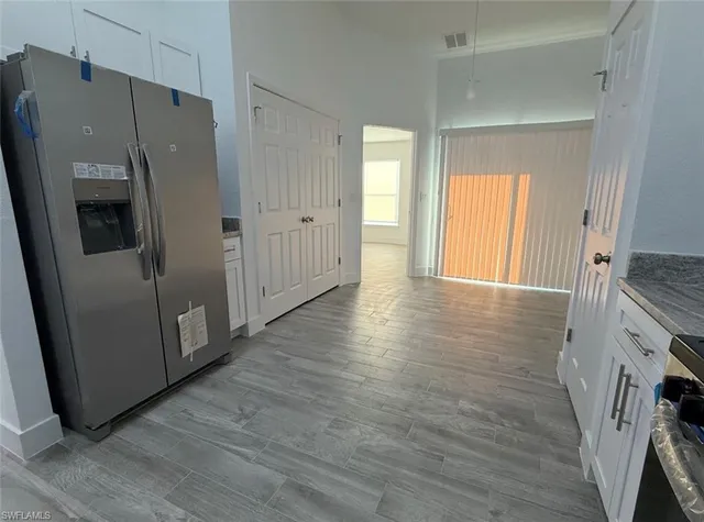 a view of a kitchen with a refrigerator and a window