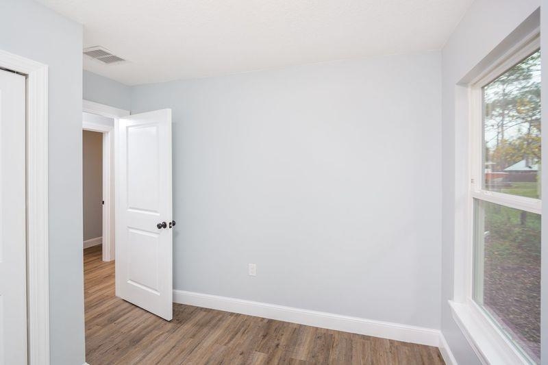 2943 North 6th Street St. Augustine, FL 32084 - Photo 11 of 17 a view of an empty room with wooden floor and a window