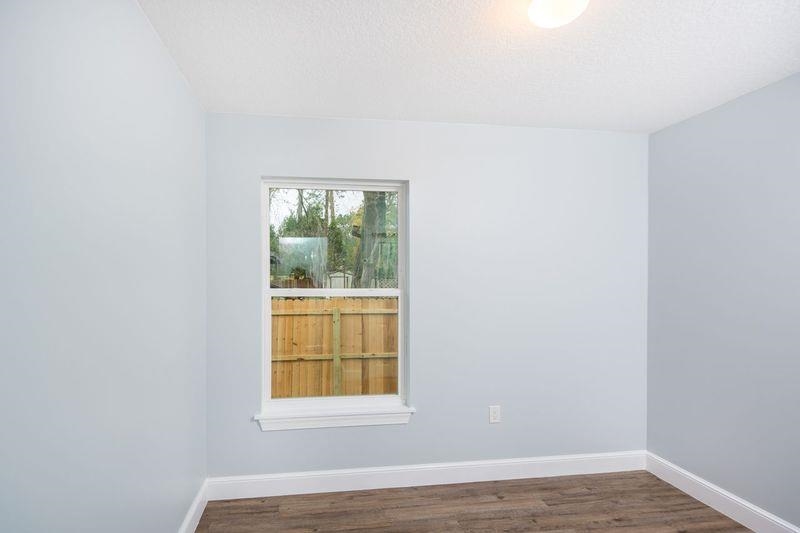 2943 North 6th Street St. Augustine, FL 32084 - Photo 13 of 17 a view of an empty room with wooden floor and a window