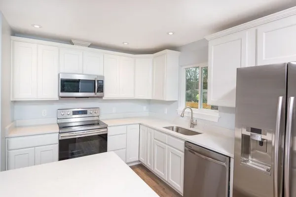 a kitchen with a refrigerator stove and microwave