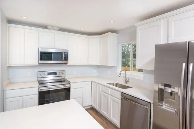 a kitchen with a refrigerator stove and microwave